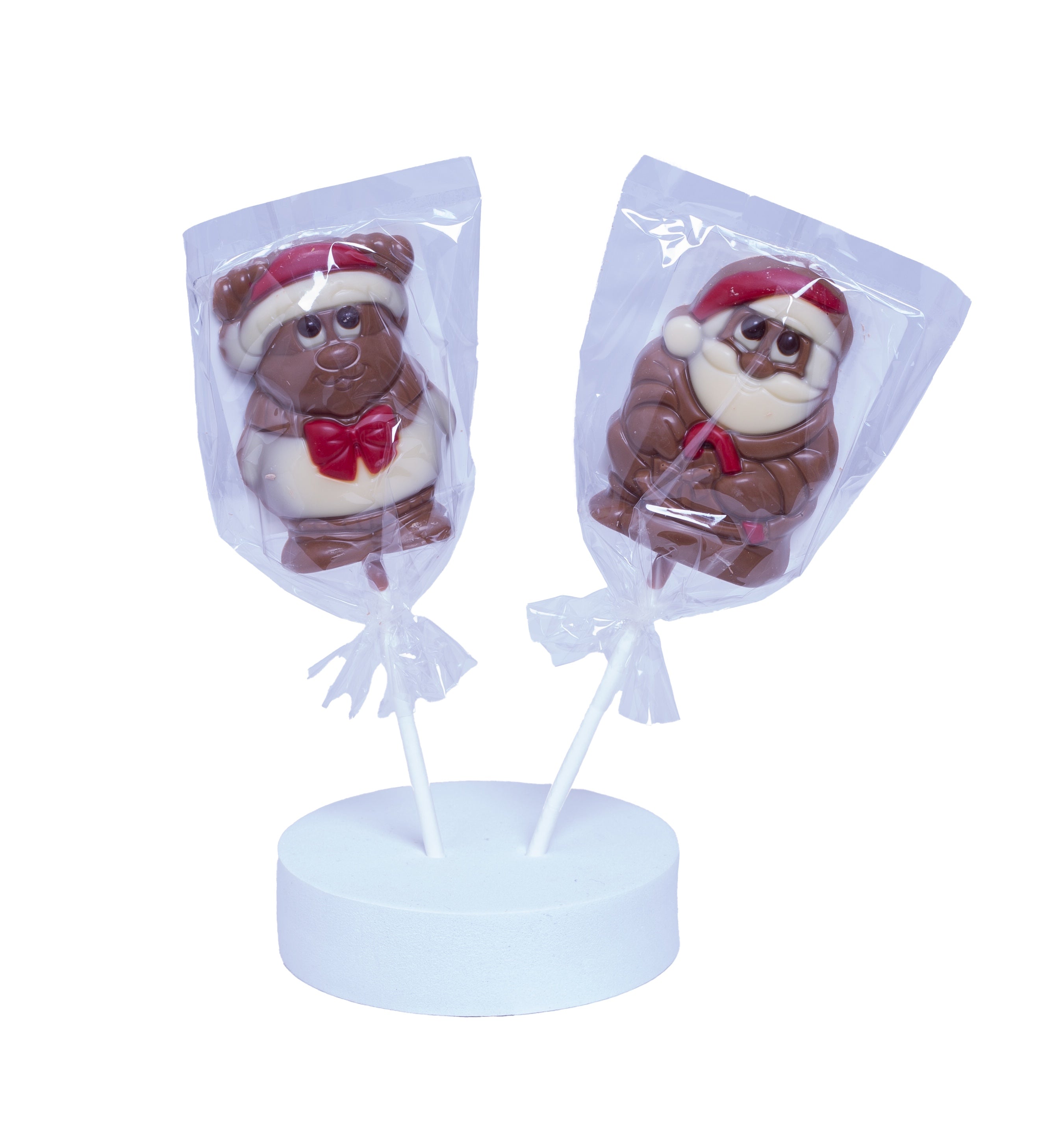 Two chocolate chocolate characters  in festive hats on sticks with clear bags, on a white background